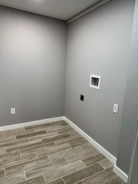 403 W Cedar St, Waverly, MO 64096 - washroom with electric dryer hookup, wood finish floors, hookup for a washing machine, and baseboards