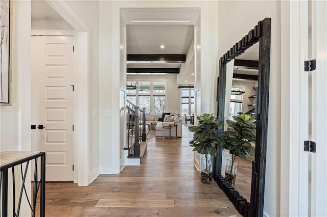 foyer featuring baseboards and wood finished floors