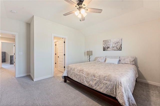 carpeted bedroom featuring baseboards, ceiling fan, and vaulted ceiling