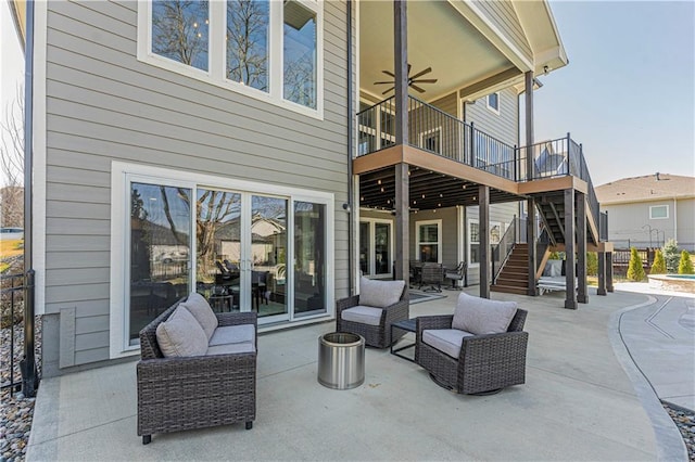 view of patio / terrace featuring an outdoor living space, a ceiling fan, stairs, and a wooden deck