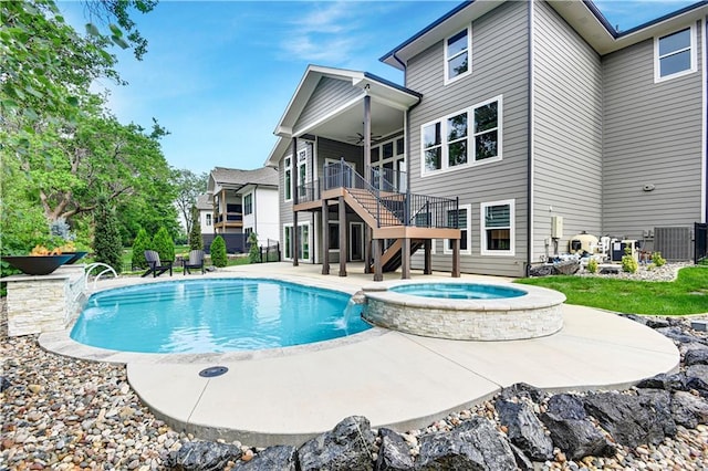 11212 W 170th Pl, Overland Park, KS 66221 - view of swimming pool with stairway, a ceiling fan, a patio, a pool with connected hot tub, and central AC