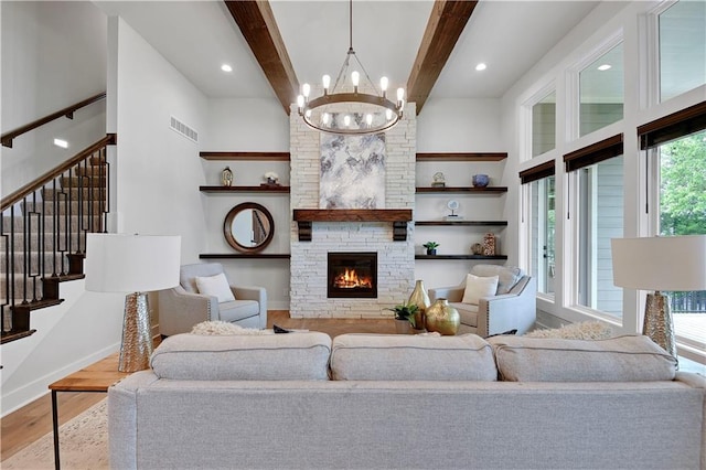 11212 W 170th Pl, Overland Park, KS 66221 - living area with wood finished floors, a chandelier, stairway, a stone fireplace, and beam ceiling