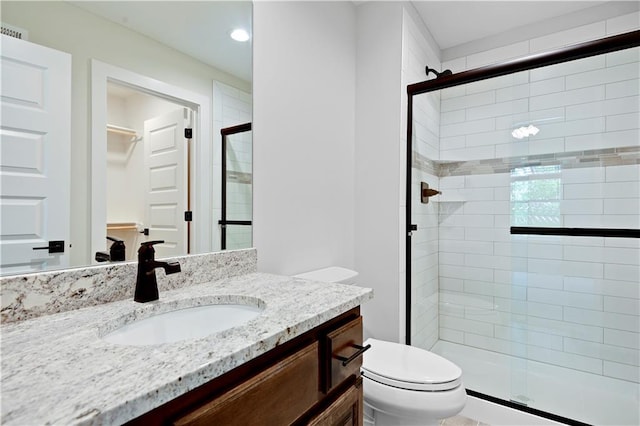 11212 W 170th Pl, Overland Park, KS 66221 - full bath featuring a shower stall, toilet, vanity, recessed lighting, and a walk in closet