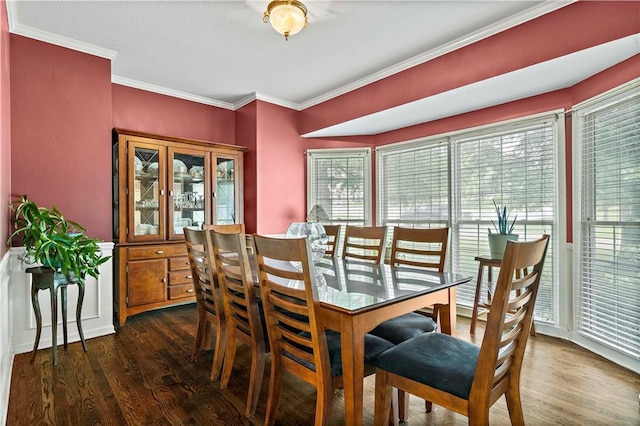 dining area with crown molding and wood finished floors
