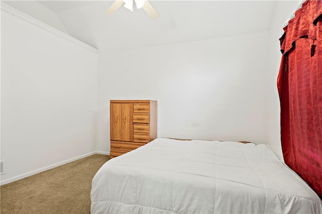 carpeted bedroom with baseboards, ceiling fan, and vaulted ceiling