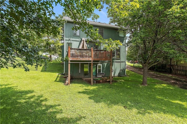 back of house with a lawn and a deck