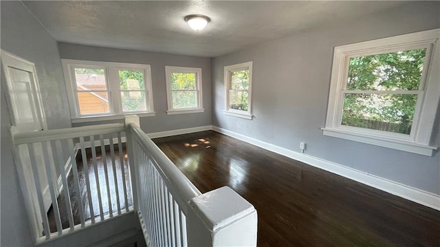 stairway with baseboards and wood finished floors