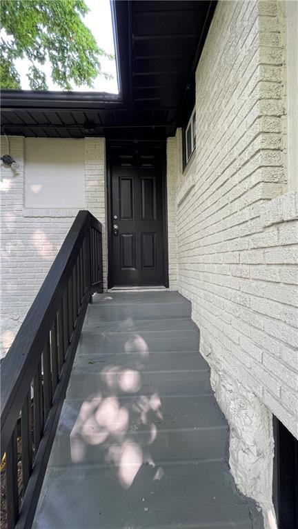 entrance to property featuring brick siding