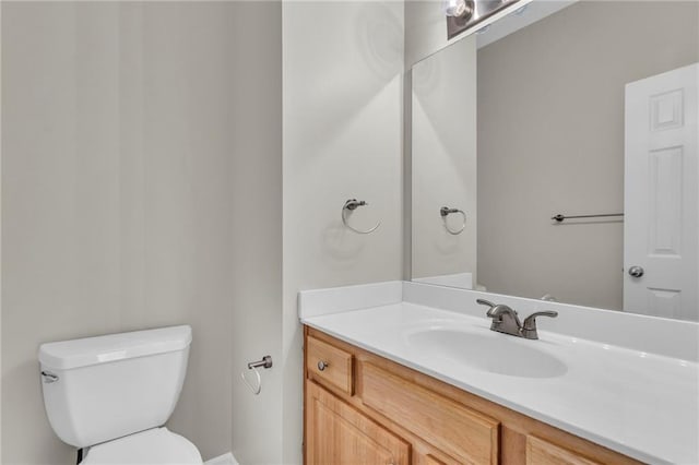 half bath featuring toilet and vanity