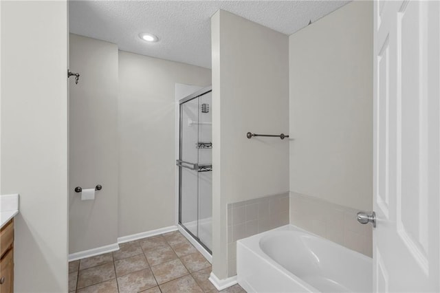 bathroom with vanity, a textured ceiling, a bath, tile patterned floors, and a stall shower