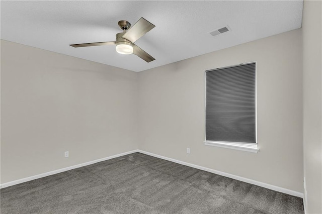 unfurnished room featuring visible vents, a ceiling fan, baseboards, and dark colored carpet