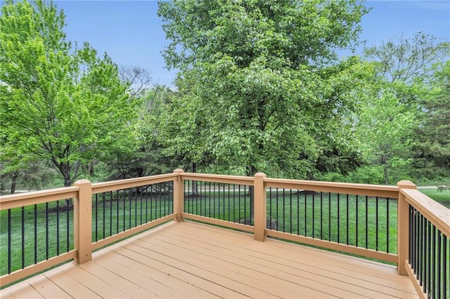 wooden deck featuring a yard