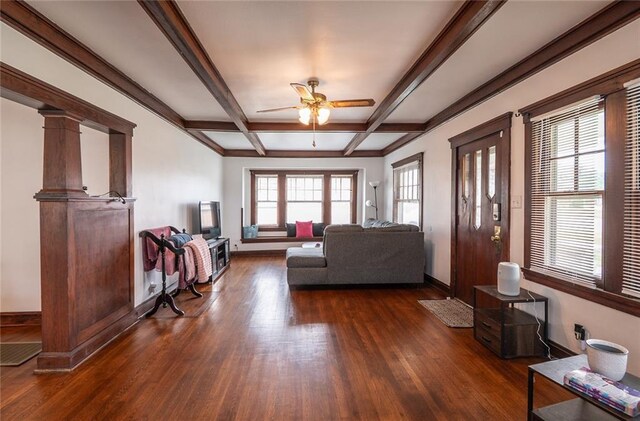 living area with baseboards, dark wood-style flooring, ceiling fan, and beamed ceiling
