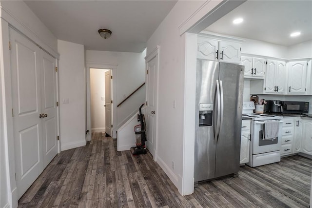 kitchen with stainless steel fridge, electric range, dark wood-style floors, and white cabinetry