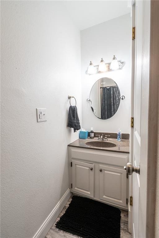 bathroom with vanity and baseboards