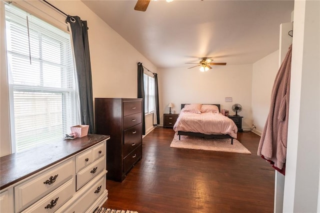 bedroom with a ceiling fan and dark wood-type flooring