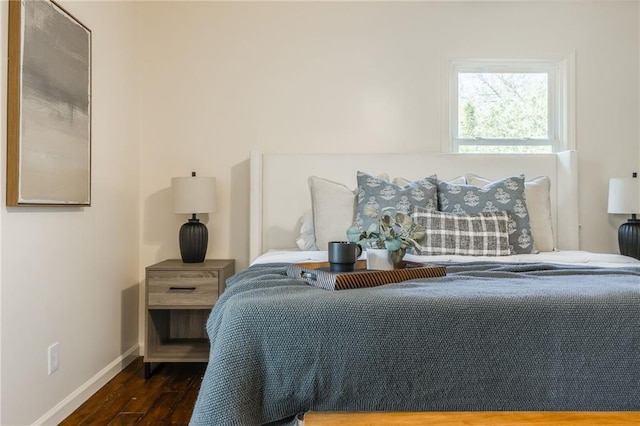 bedroom with baseboards and dark wood finished floors