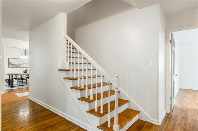 stairs with baseboards and wood finished floors