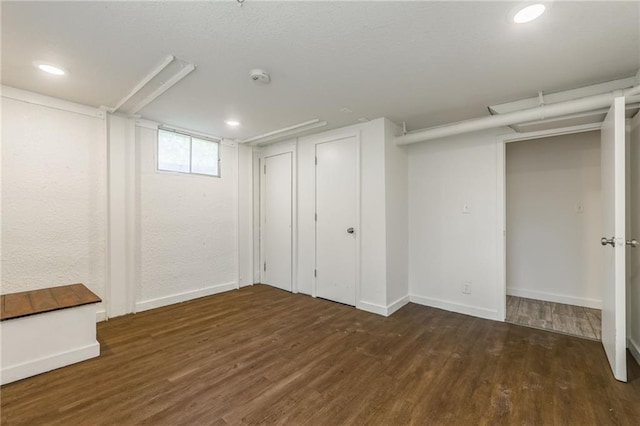 below grade area featuring baseboards, recessed lighting, and wood finished floors