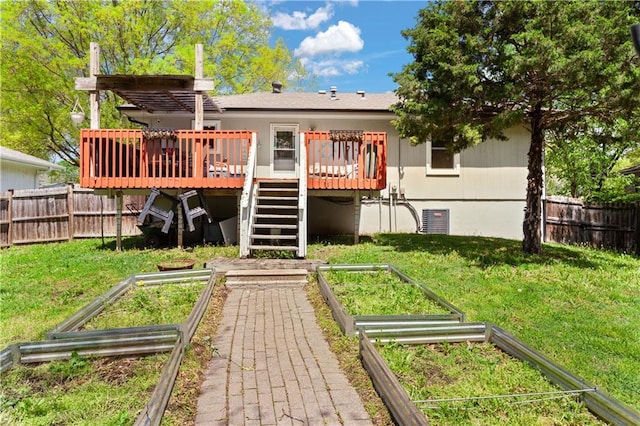 rear view of house featuring stairs, a garden, and fence