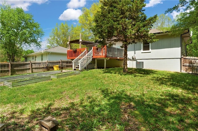 back of property featuring fence, a lawn, a deck, and cooling unit