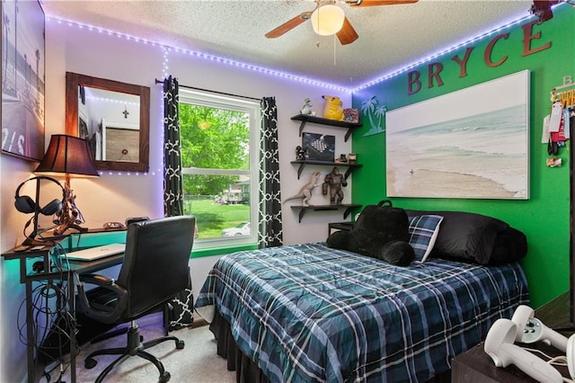 carpeted bedroom with a textured ceiling and ceiling fan