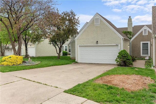 9629 N Locust Dr, Kansas City, MO 64155 - view of home's exterior featuring a garage, stucco siding, a yard, and concrete driveway