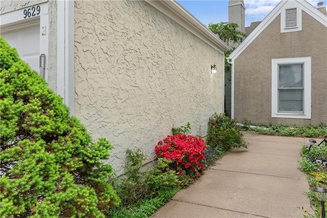 9629 N Locust Dr, Kansas City, MO 64155 - view of property exterior featuring a patio and stucco siding