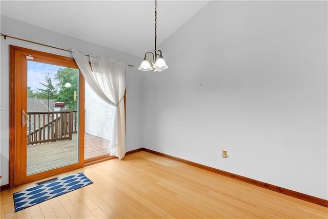 9629 N Locust Dr, Kansas City, MO 64155 - interior space featuring an inviting chandelier, visible vents, light wood finished floors, baseboards, and vaulted ceiling