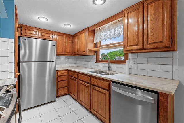 9629 N Locust Dr, Kansas City, MO 64155 - kitchen featuring decorative backsplash, a textured ceiling, appliances with stainless steel finishes, brown cabinets, and a sink