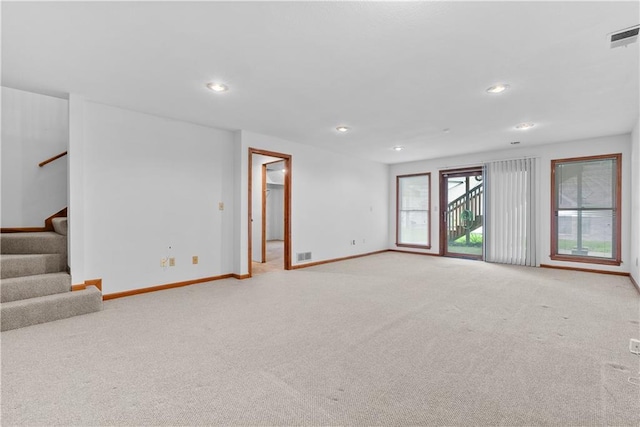 9629 N Locust Dr, Kansas City, MO 64155 - unfurnished living room featuring recessed lighting, baseboards, and light carpet