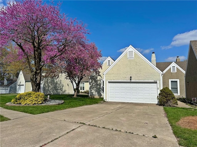 9629 N Locust Dr, Kansas City, MO 64155 - view of property exterior featuring a garage, stucco siding, a chimney, concrete driveway, and a lawn