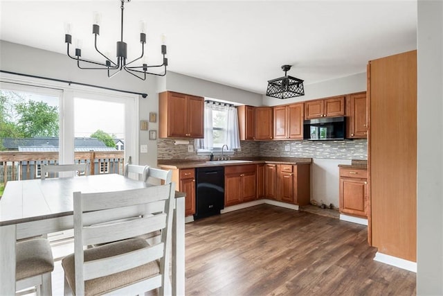 kitchen featuring a sink, black dishwasher, and brown cabinetry