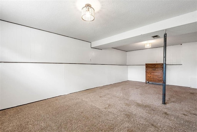 finished basement with carpet floors and a textured ceiling