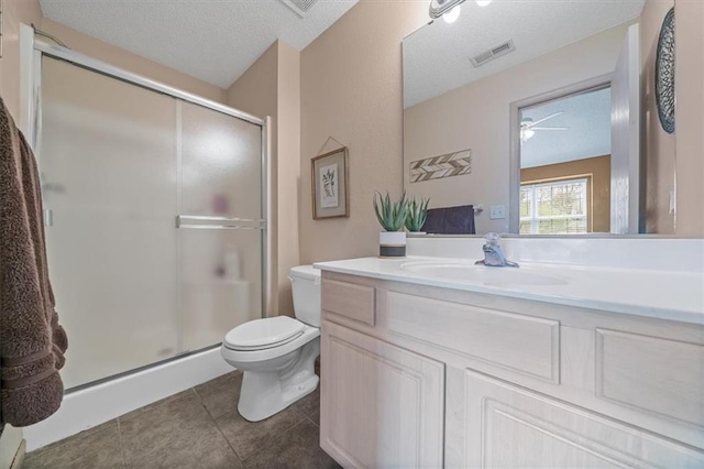 full bathroom with a textured ceiling, visible vents, a shower stall, vanity, and toilet