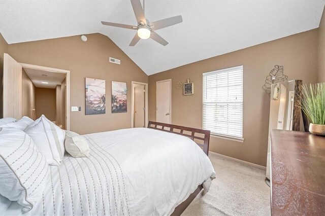 bedroom featuring light colored carpet, a ceiling fan, baseboards, lofted ceiling, and visible vents
