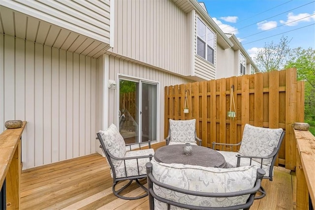 wooden terrace featuring fence and outdoor dining area
