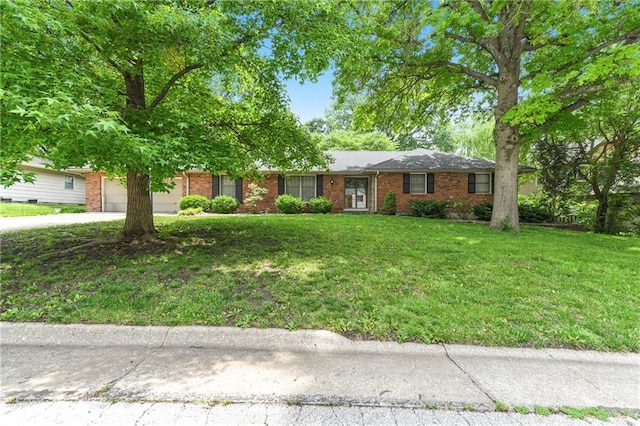 2217 Kingman St, Leavenworth, KS 66048 - ranch-style home featuring a garage, brick siding, driveway, and a front lawn