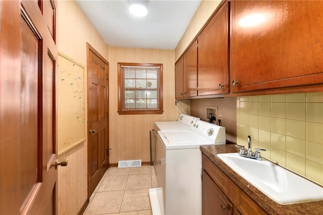 2217 Kingman St, Leavenworth, KS 66048 - washroom with washer and clothes dryer, cabinet space, and light tile patterned flooring