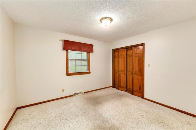 2217 Kingman St, Leavenworth, KS 66048 - unfurnished bedroom featuring a closet and a textured ceiling