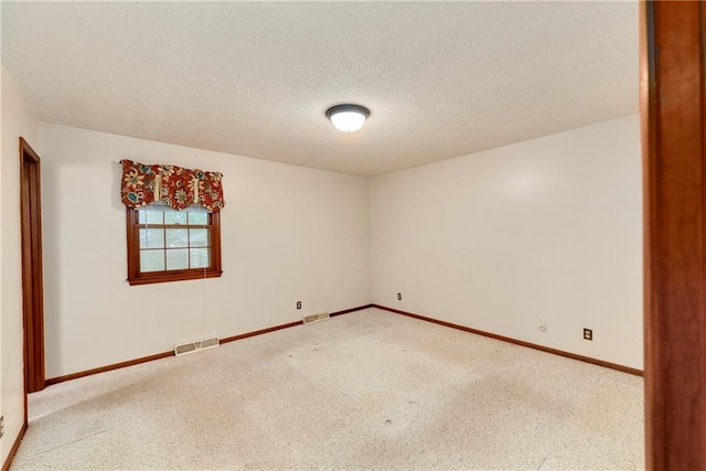 2217 Kingman St, Leavenworth, KS 66048 - carpeted empty room featuring baseboards and a textured ceiling