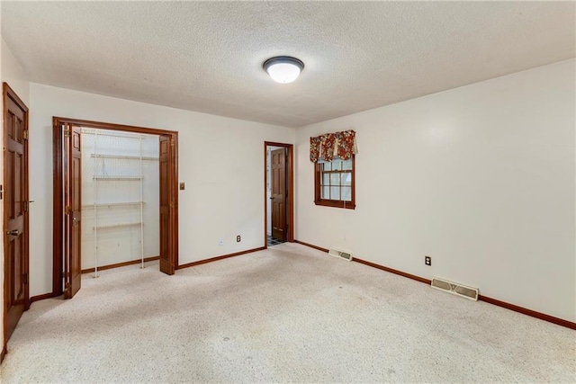 2217 Kingman St, Leavenworth, KS 66048 - unfurnished bedroom featuring a textured ceiling, a closet, and light carpet