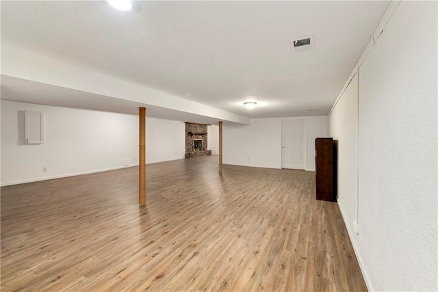 2217 Kingman St, Leavenworth, KS 66048 - finished below grade area with light wood-style floors and a fireplace