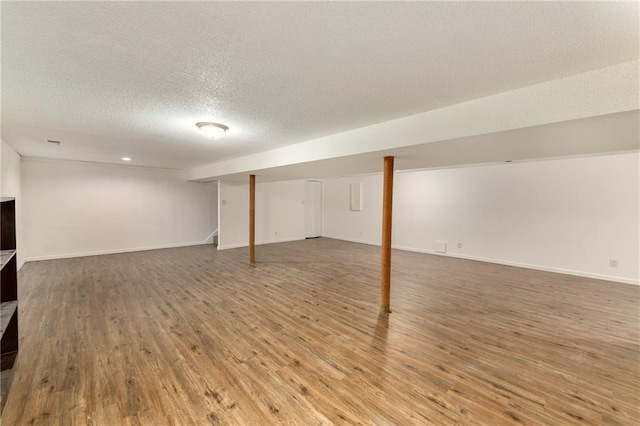 2217 Kingman St, Leavenworth, KS 66048 - finished below grade area with wood finished floors and a textured ceiling