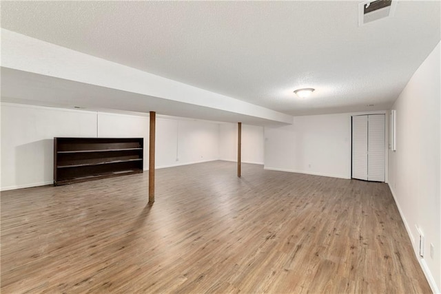 2217 Kingman St, Leavenworth, KS 66048 - finished below grade area featuring light wood-style floors and a textured ceiling