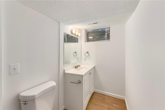 2217 Kingman St, Leavenworth, KS 66048 - bathroom with vanity, a textured ceiling, and wood finished floors