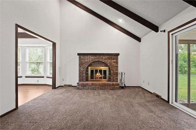 18104 E 24th St S, Independence, MO 64057 - unfurnished living room with carpet flooring, beamed ceiling, plenty of natural light, high vaulted ceiling, and a brick fireplace