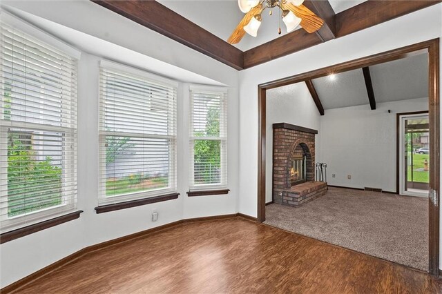 18104 E 24th St S, Independence, MO 64057 - unfurnished living room featuring healthy amount of natural light, wood finished floors, ceiling fan, and a brick fireplace