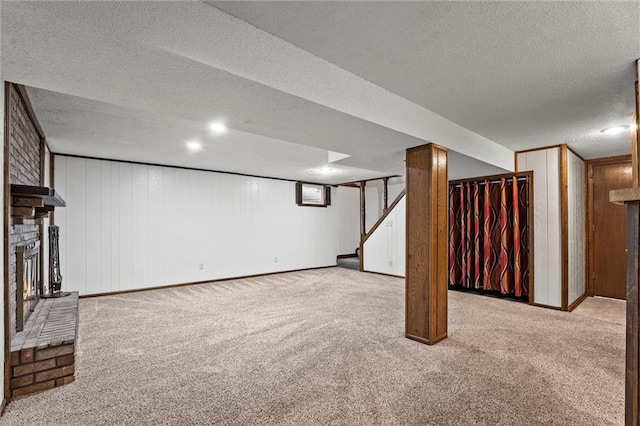 18104 E 24th St S, Independence, MO 64057 - finished basement with carpet floors, a fireplace, a textured ceiling, and stairway