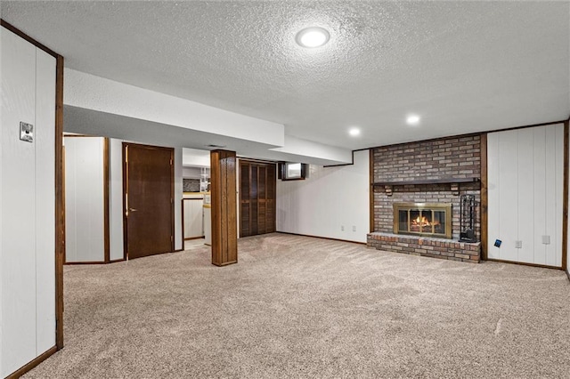 18104 E 24th St S, Independence, MO 64057 - finished below grade area featuring a textured ceiling, carpet flooring, a brick fireplace, and baseboards